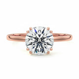 Engagement ring round cut Moissanite lab grown diamond engagement ring round shank with four  double cat law setting, on a gold band, against a white background.Moissanite engagement ring cape town south africa grand diamonds ralph jacobs jeulia 