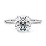 Engagement ring round cut Moissanite lab grown diamond engagement ring round shank with four  double cat law setting, on a gold band, against a white background.Moissanite engagement ring cape town south africa grand diamonds ralph jacobs jeulia 