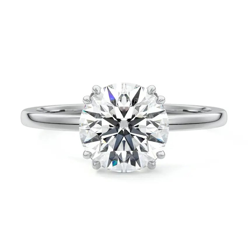 Engagement ring round cut Moissanite lab grown diamond engagement ring round shank with four  double cat law setting, on a gold band, against a white background.Moissanite engagement ring cape town south africa grand diamonds ralph jacobs jeulia 