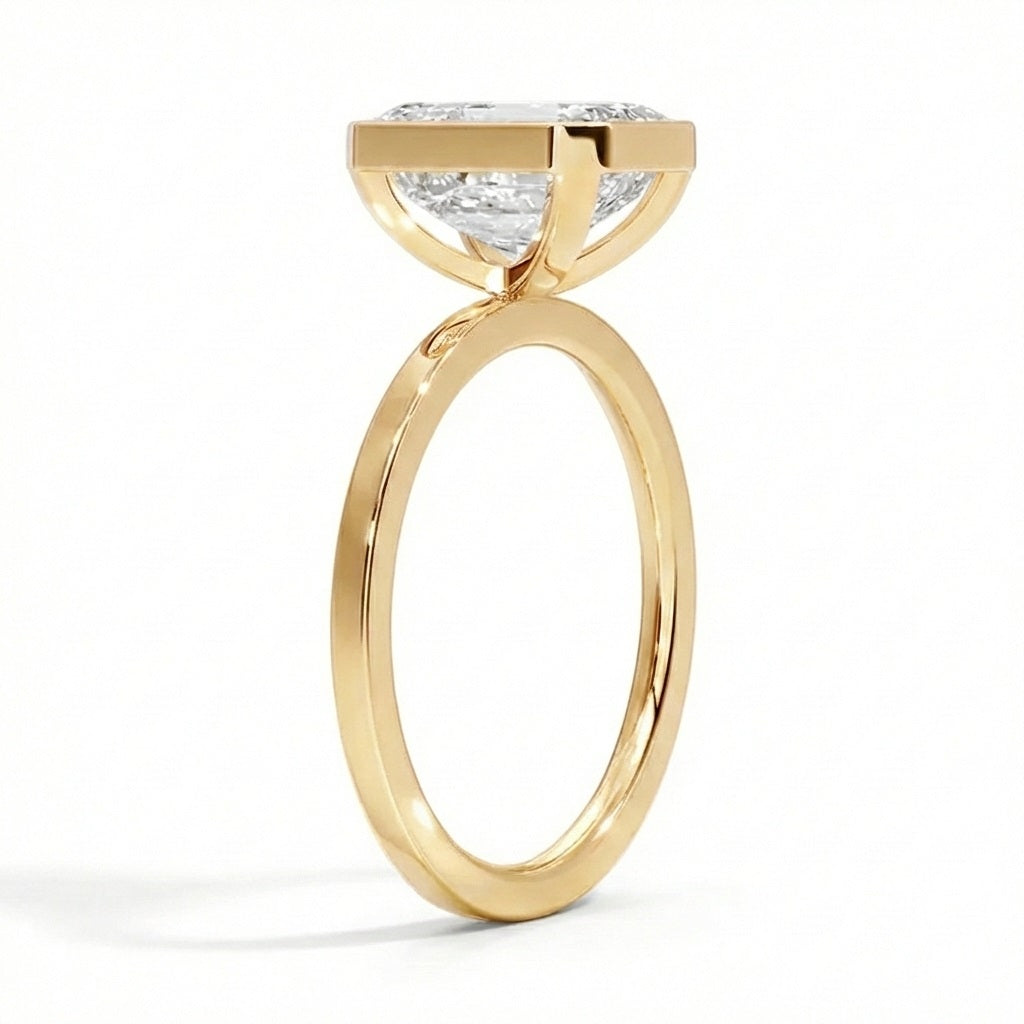 Flat band engagement ring bezel set emerald cut yellow gold modern style South Africa
