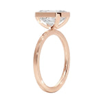 Top-down view of a D-color VVS1 emerald brilliance moissanite in a rose gold solitaire setting.