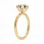 Top-down view of a D-color VVS1 round stone in a polished yellow gold bezel setting