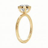 Top-down view of a D-color VVS1 round stone in a polished yellow gold bezel setting
