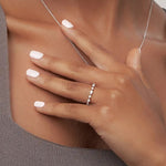 Unique mixed shape wedding band affordable luxury moissanite ring online store
Close-up of a hand wearing a silver ring with a blurred background