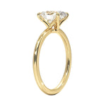 Detailed side view of a four-prong cushion moissanite ring showing the slim polished gold band.