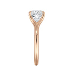 Close-up of a high-quality D-color VVS1 cushion moissanite in an elegant architectural gold setting.
