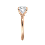 Close-up of a high-quality D-color VVS1 cushion moissanite in an elegant architectural gold setting.