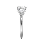 Close-up of a high-quality D-color VVS1 cushion moissanite in an elegant architectural gold setting.