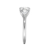 Close-up of a high-quality D-color VVS1 cushion moissanite in an elegant architectural gold setting.