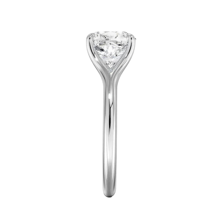 Close-up of a high-quality D-color VVS1 cushion moissanite in an elegant architectural gold setting.