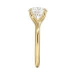 Close-up of a high-quality D-color VVS1 cushion moissanite in an elegant architectural gold setting.