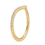 Close-up of a chevron wedding ring in yellow gold with micro-pavé set moissanite stones.