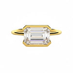 Emerald cut moissanite solitaire engagement ring in a modern East-West column setting ApolloGem.