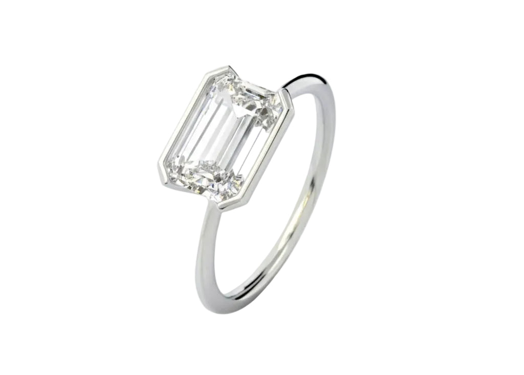 Symmetrical top-down view of an emerald moissanite horizontally set on a polished gold band.