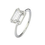 Symmetrical top-down view of an emerald moissanite horizontally set on a polished gold band.