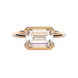 Emerald cut moissanite solitaire engagement ring in a modern East-West column setting ApolloGem.