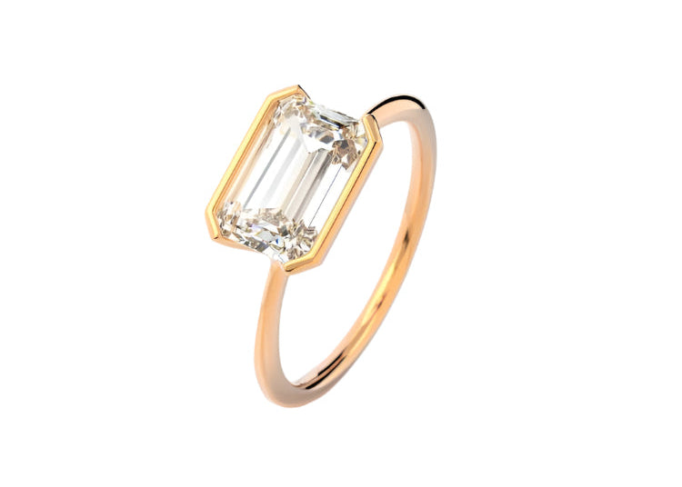 Symmetrical top-down view of an emerald moissanite horizontally set on a polished gold band.