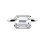 Emerald cut moissanite solitaire engagement ring in a modern East-West column setting ApolloGem.