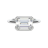 Emerald cut moissanite solitaire engagement ring in a modern East-West column setting ApolloGem.
