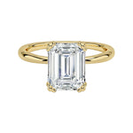 Luxury emerald cut moissanite solitaire engagement ring with double claw setting in yellow gold ApolloGem South Africa.