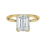 Luxury emerald cut moissanite solitaire engagement ring with double claw setting in yellow gold ApolloGem South Africa.