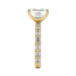 Top-down view of a symmetrical emerald cut moissanite ring on a luxurious step-cut eternity gold band.
