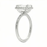 Silver ring with a diamond halo on a white background