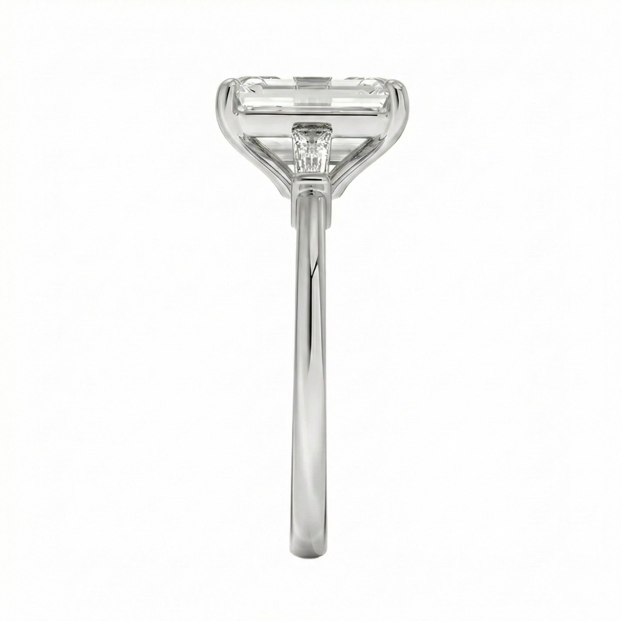 Close up of emerald cut and baguette moissanite stones in four prong setting