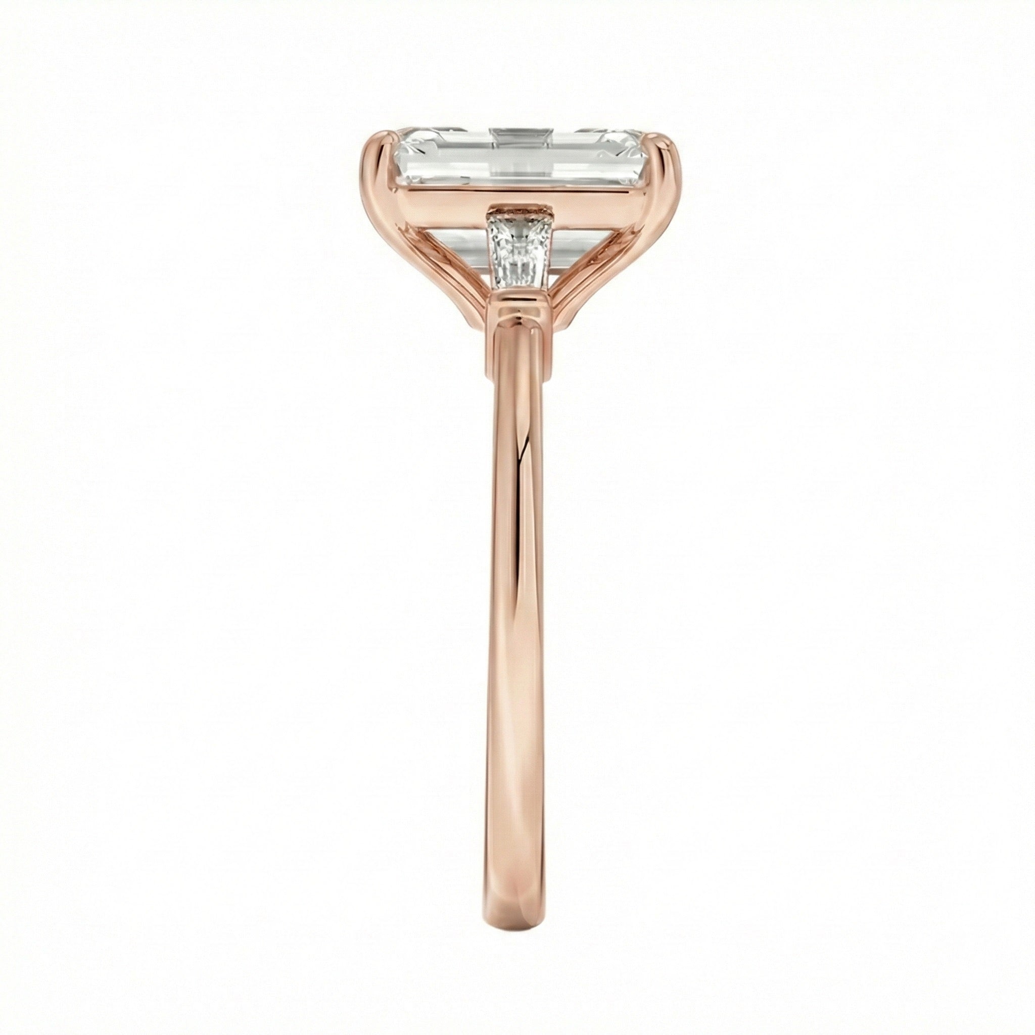 Rose gold ring with a rectangular diamond on a white background ApoloGem Engagement ring Emerald cut rose gold