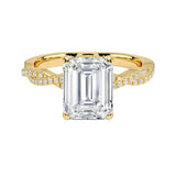 Four-claw emerald cut moissanite engagement ring with a pavé infinity twist vine band in yellow gold ApolloGem.