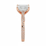 Top-down view of a D-color VVS1 emerald stone in a rose gold infinity twist setting.