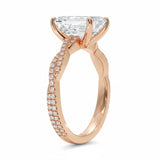 Side profile of the Emerald Infinity Twist ring showing the interlocking smooth and pavé-set gold bands.
