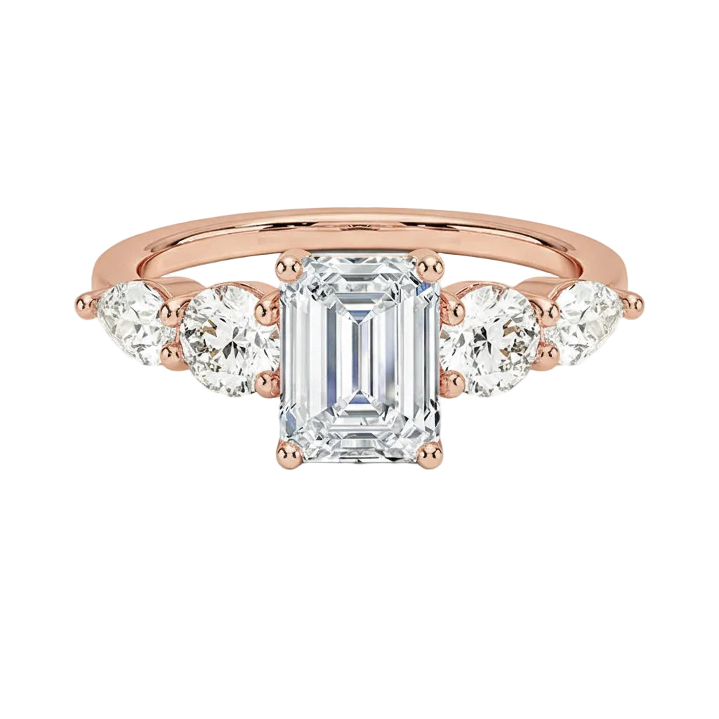 Rose gold emerald cut moissanite ring with graduated pear side stones