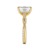 Top-down view of a D-color VVS1 emerald stone in an asymmetrical yellow gold infinity setting.
