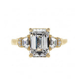 Grand emerald cut moissanite engagement ring in a heavy three-stone solid gold setting ApolloGem.