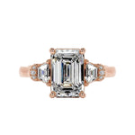 Grand emerald cut moissanite engagement ring in a heavy three-stone solid gold setting ApolloGem.