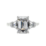 Grand emerald cut moissanite engagement ring in a heavy three-stone solid gold setting ApolloGem.