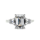Grand emerald cut moissanite engagement ring in a heavy three-stone solid gold setting ApolloGem.
