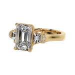 Symmetrical top-down view of the triple emerald-cut moissanite masterpiece in yellow gold.