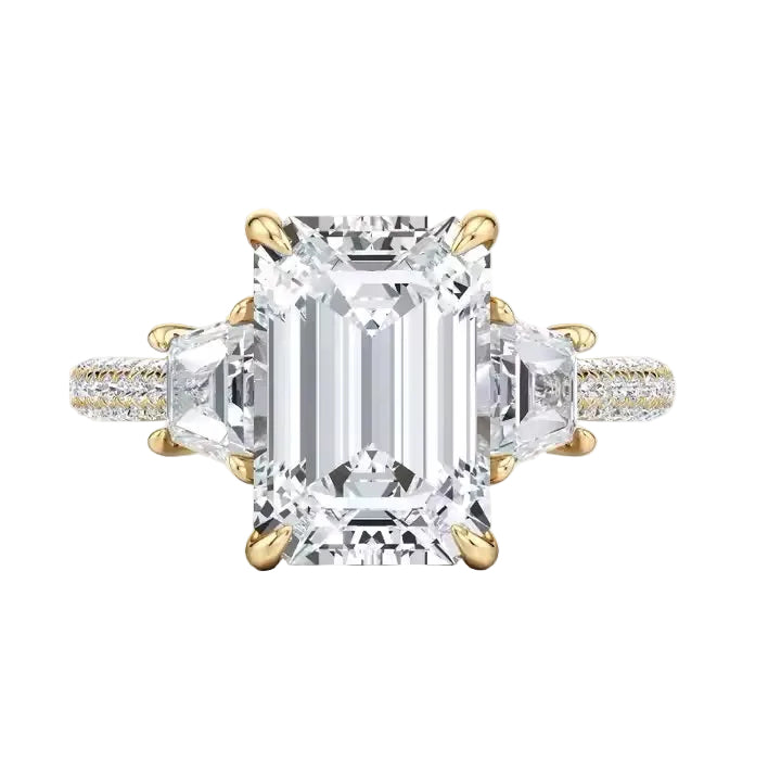 Luxury emerald cut moissanite engagement ring with trapezoid side stones and triple-row pavé band in yellow gold ApolloGem.