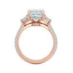 Top-down view of a symmetrical emerald and trapezoid moissanite ring on a luxurious triple-row pavé gold band.