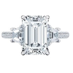 Luxury emerald cut moissanite engagement ring with trapezoid side stones and triple-row pavé band in white  gold ApolloGem.