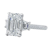 Luxury emerald cut moissanite engagement ring with trapezoid side stones and triple-row pavé band in white gold ApolloGem.