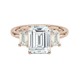 Grand emerald cut moissanite trilogy engagement ring in rose gold ApolloGem.