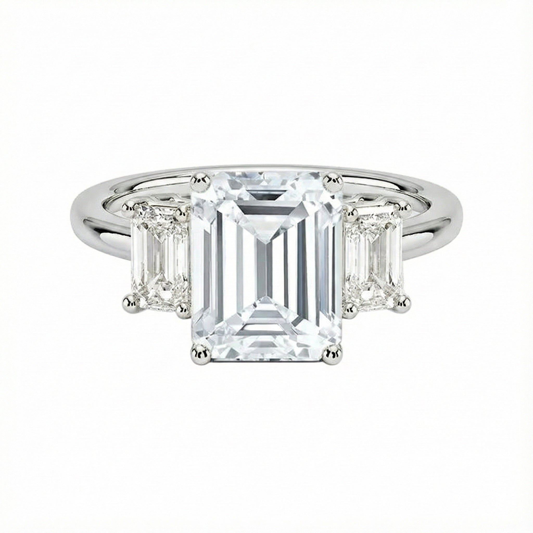 Grand emerald cut moissanite trilogy engagement ring in white gold ApolloGem.
