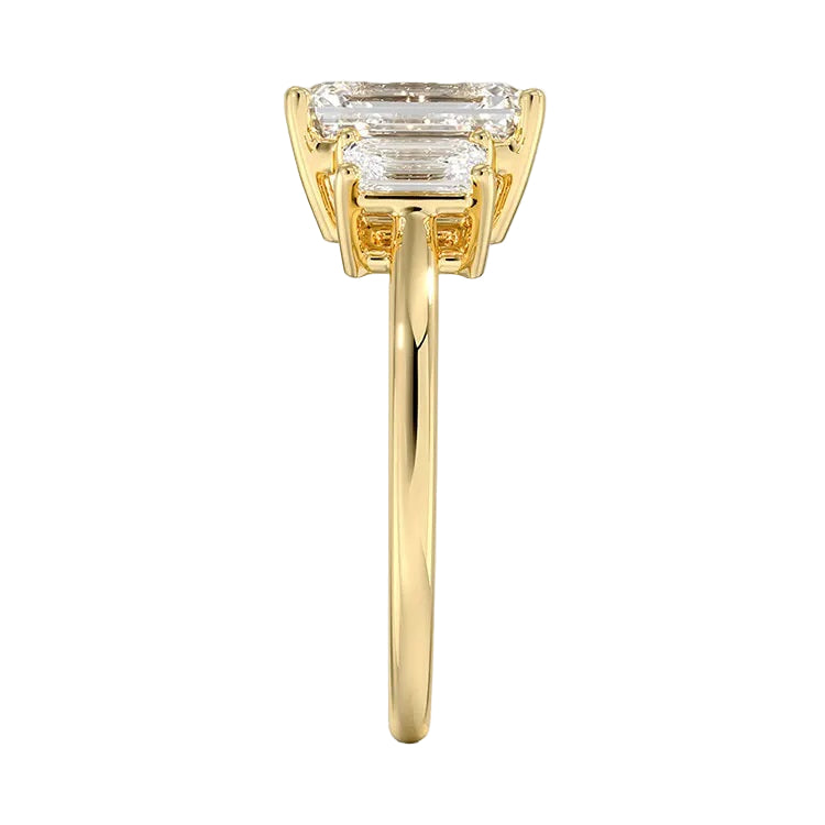 Symmetrical top-down view of a graduated triple emerald-cut moissanite ring in polished solid gold.