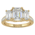 Emerald cut moissanite trilogy engagement ring with a pavé-set yellow gold band ApolloGem.