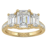 Emerald cut moissanite trilogy engagement ring with a pavé-set yellow gold band ApolloGem.