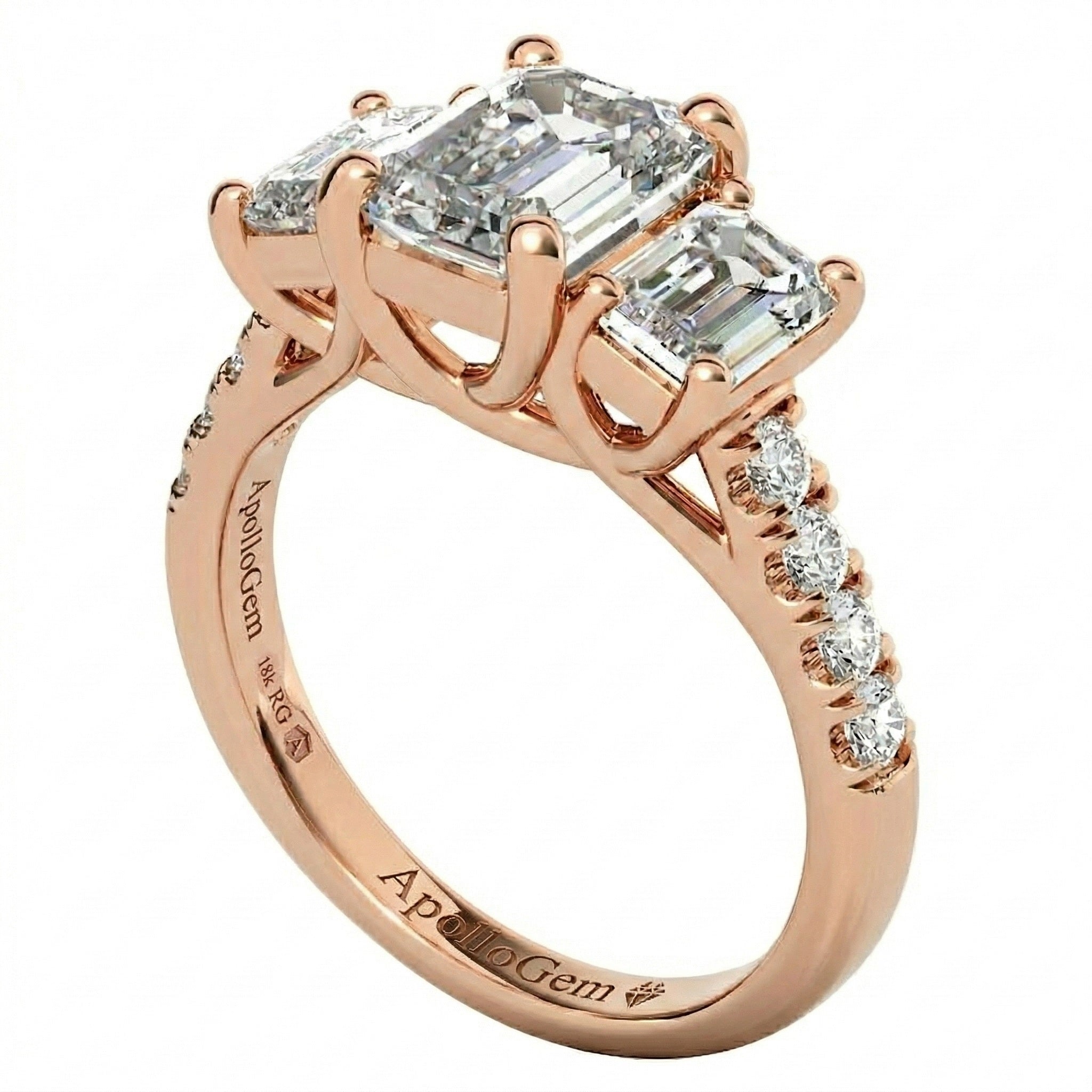 Top-down view of a D-color VVS1 graduated three-stone emerald moissanite ring with accent stones.