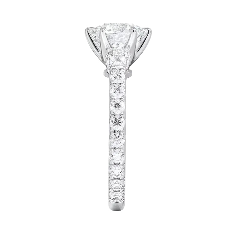 Diamond ring with a central diamond and smaller diamonds on the band against a white background
